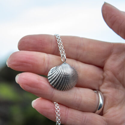 cockle-shell-necklace-on-hand