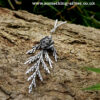 Sterling silver cedar leaf & seed necklace with natural background