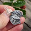 sterling silver Bramble leaf drop earring in hand 2