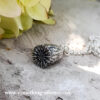 Sterling silver flanders poppy head pendant with silver belcher chain , with flower in background