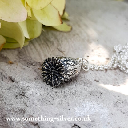 Sterling silver flanders poppy head pendant with silver belcher chain , with flower in background