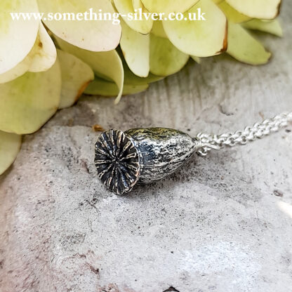 Sterling silver flanders poppy head pendant with silver belcher chain , with flower in background 2