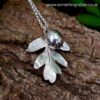 sterling silver hawthorn leaf and berry with bark background