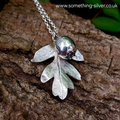 sterling silver hawthorn leaf and berry with bark background